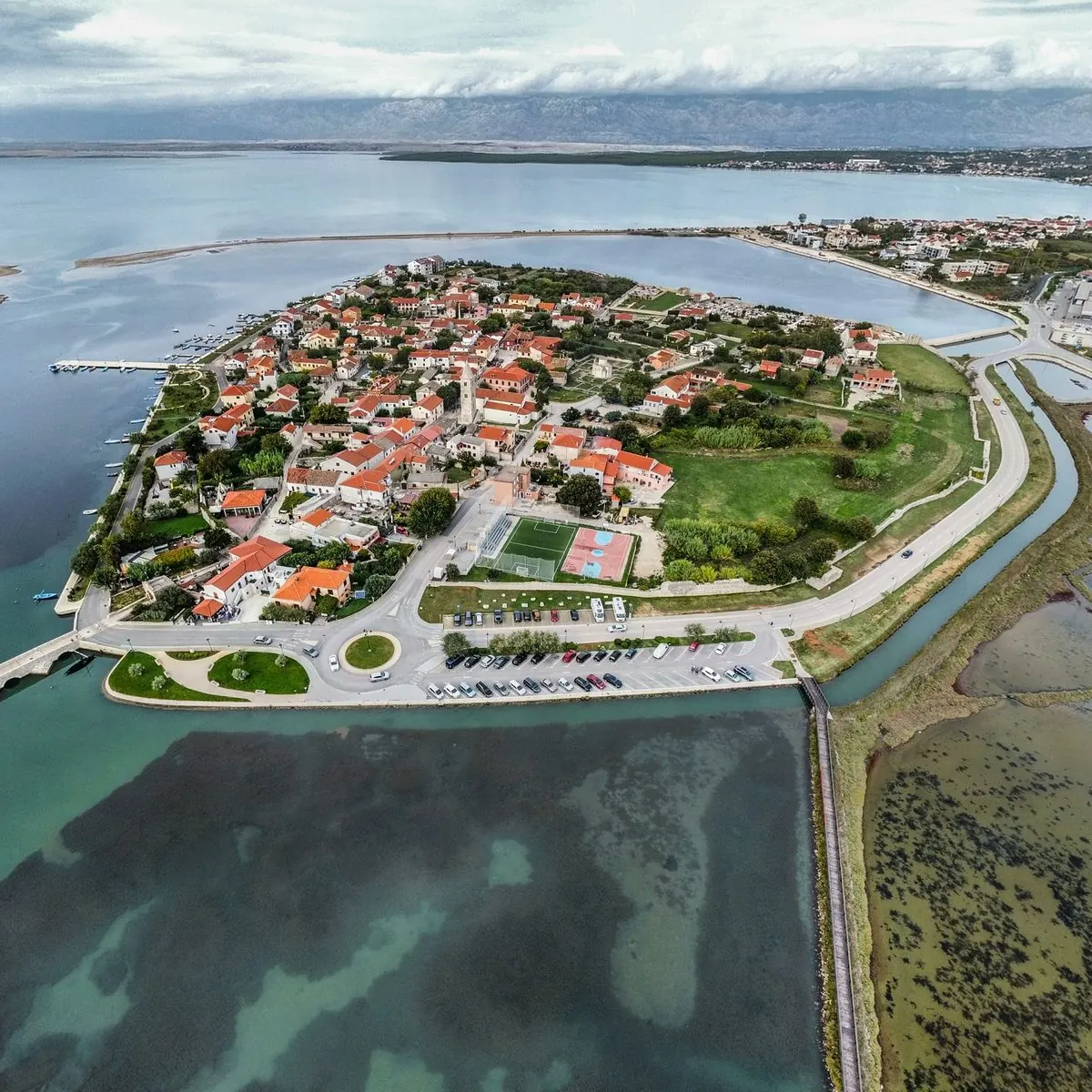 Aerial view of the historic island town of Nin, surrounded by shallow lagoons