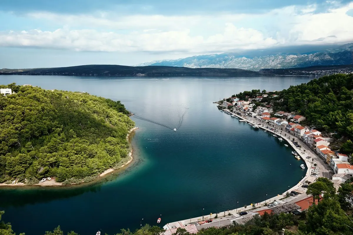 Aerial view of Novigrad's fjord-like bay, the stone village lining the water with mountains behind